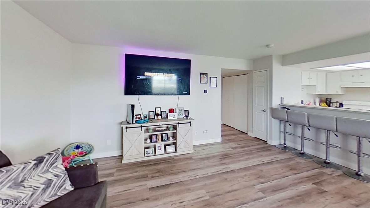 2201 James Bilbray Drive Las Vegas, NV 89108 - Photo 10 of 33 Living room with light wood-style floors and baseboards