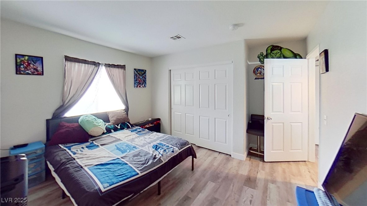 2201 James Bilbray Drive Las Vegas, NV 89108 - Photo 11 of 33 Bedroom featuring light wood-style flooring and a closet