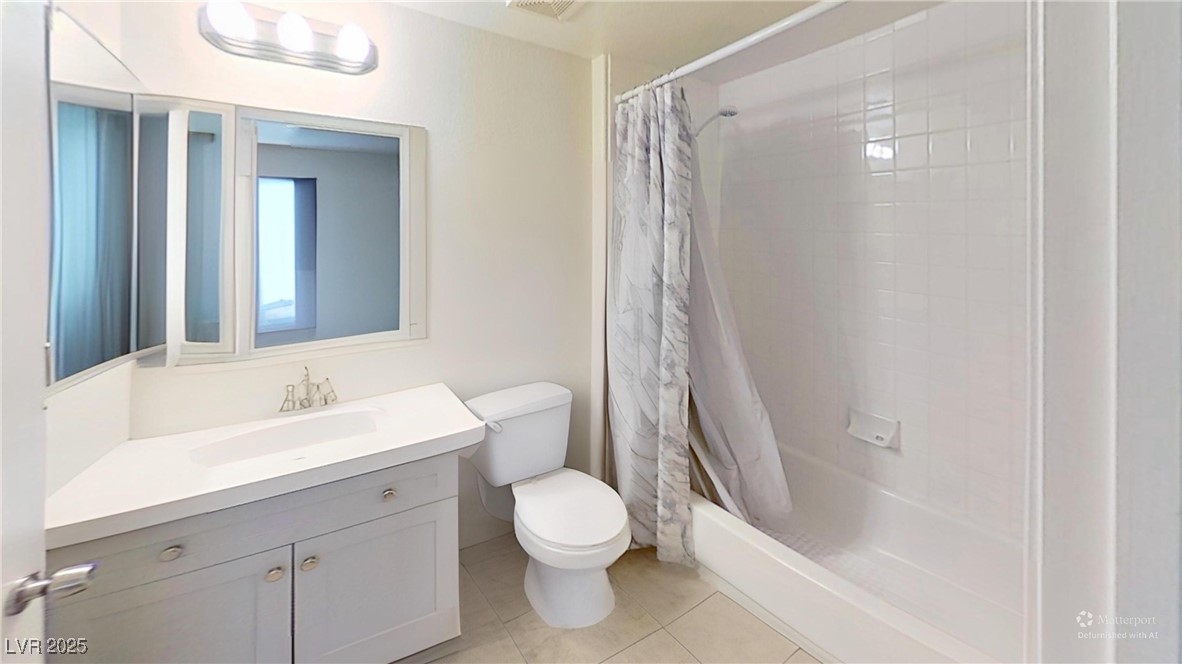 2201 James Bilbray Drive Las Vegas, NV 89108 - Photo 15 of 33 Bathroom featuring shower / bath combo with shower curtain, vanity, and light tile patterned floors