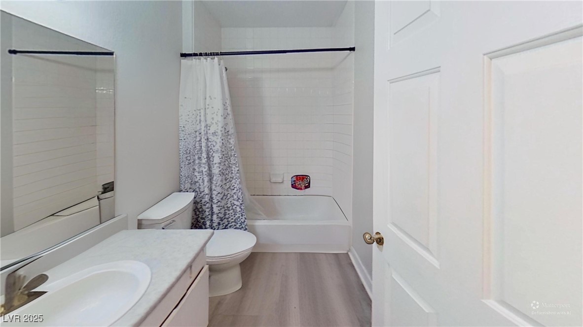 2201 James Bilbray Drive Las Vegas, NV 89108 - Photo 18 of 33 Bathroom with light wood-style flooring, shower / bath combo with shower curtain, and vanity