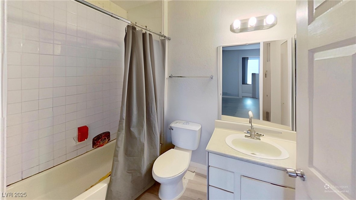 2201 James Bilbray Drive Las Vegas, NV 89108 - Photo 19 of 33 Bathroom with shower / bathtub combination with curtain, vanity, and light wood finished floors