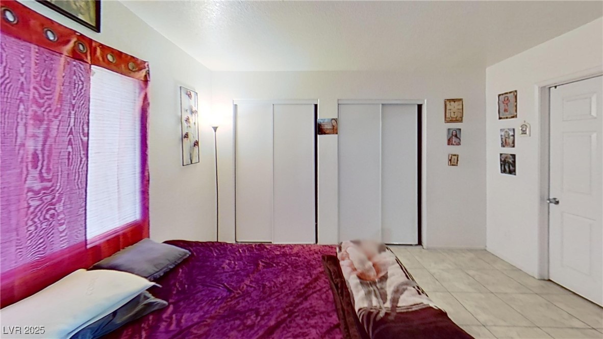 2201 James Bilbray Drive Las Vegas, NV 89108 - Photo 23 of 33 Bedroom with multiple closets and light tile patterned flooring