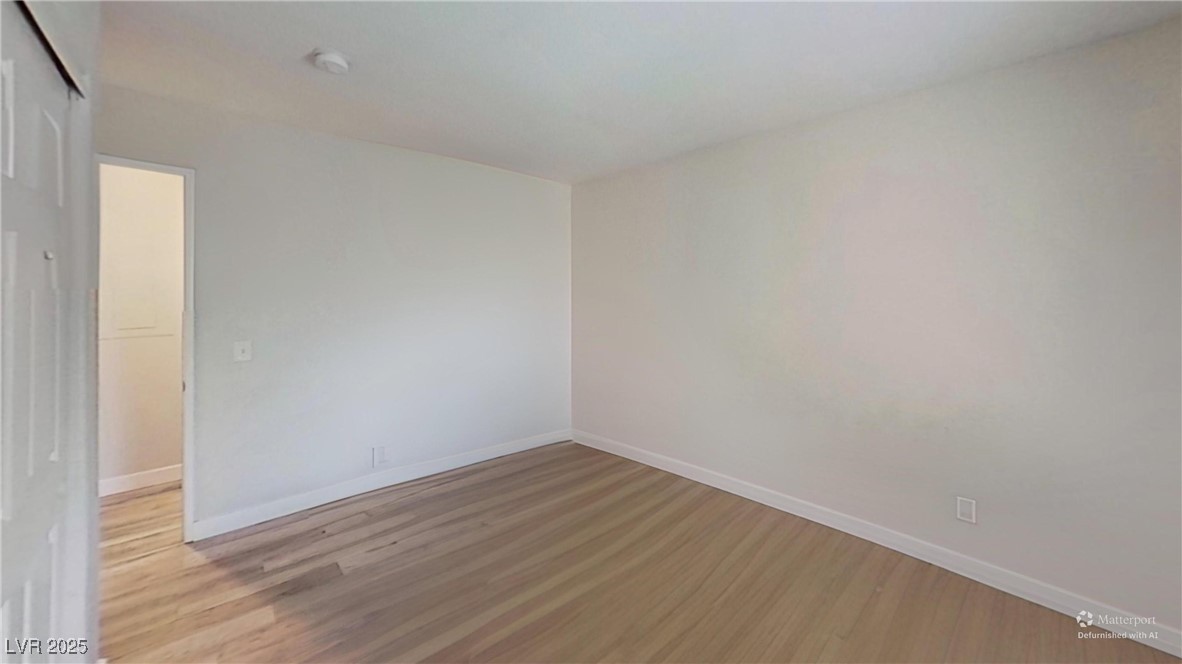 2201 James Bilbray Drive Las Vegas, NV 89108 - Photo 31 of 33 Spare room featuring wood finished floors and baseboards