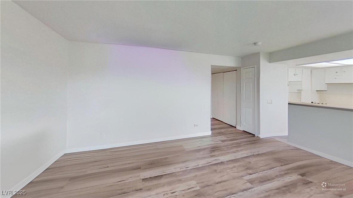 2201 James Bilbray Drive Las Vegas, NV 89108 - Photo 5 of 33 Unfurnished living room with light wood-style floors and baseboards