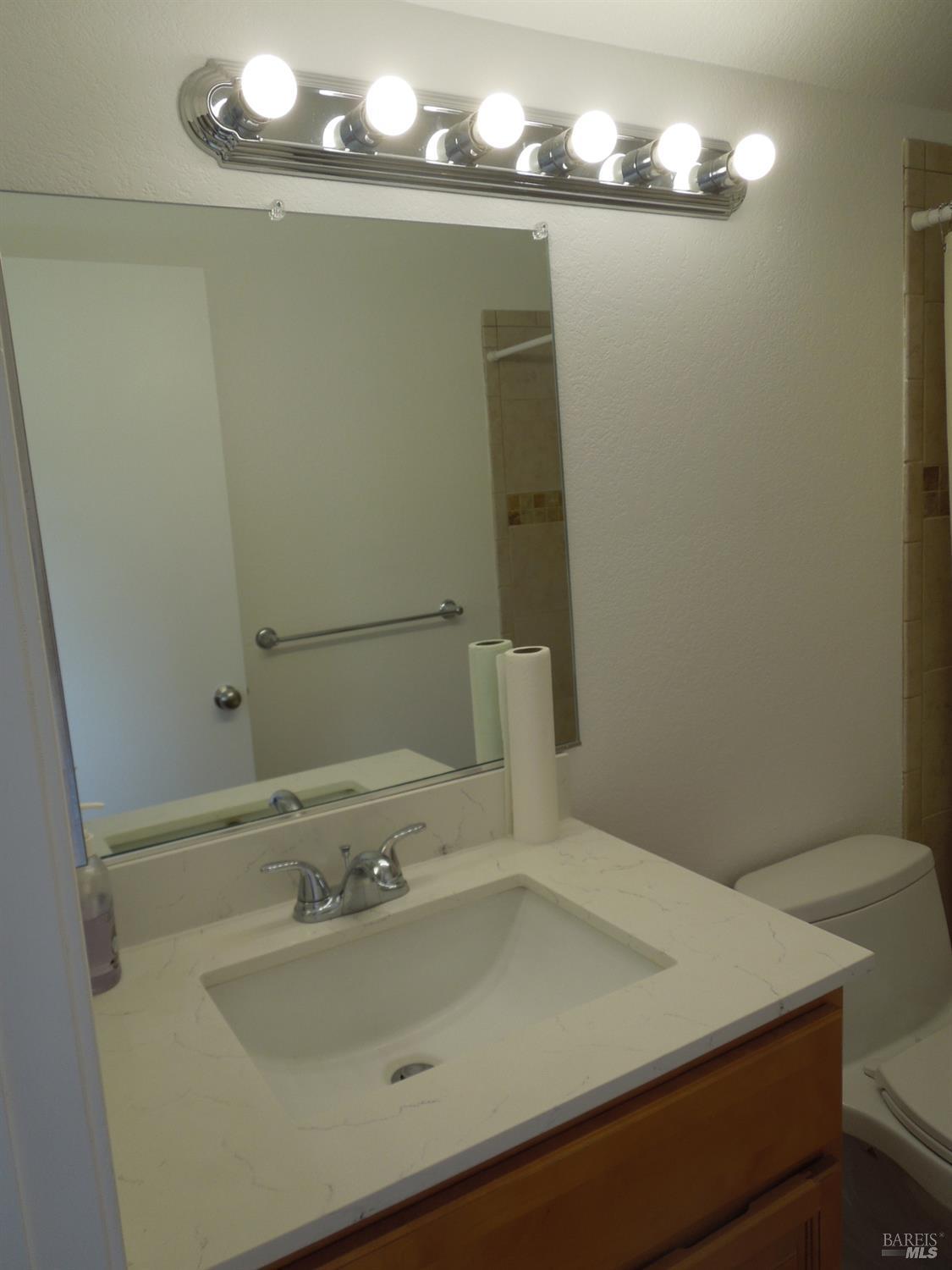 2802 Woodlake Drive Santa Rosa, CA 95405 - Photo 15 of 19 a bathroom with a sink and a mirror
