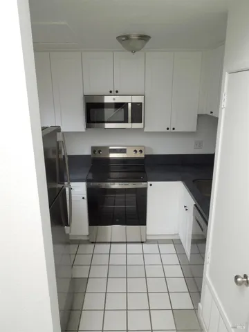 a kitchen with a stove a sink and a microwave