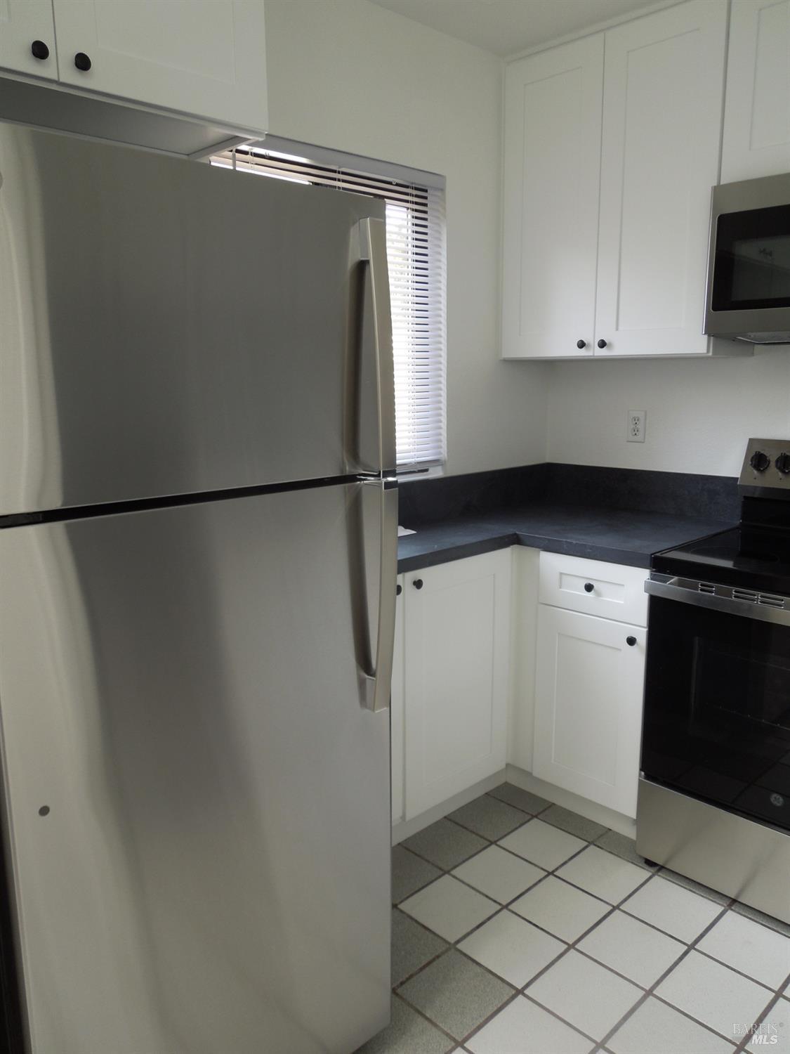 2802 Woodlake Drive Santa Rosa, CA 95405 - Photo 5 of 19 a kitchen with a refrigerator and a stove top oven
