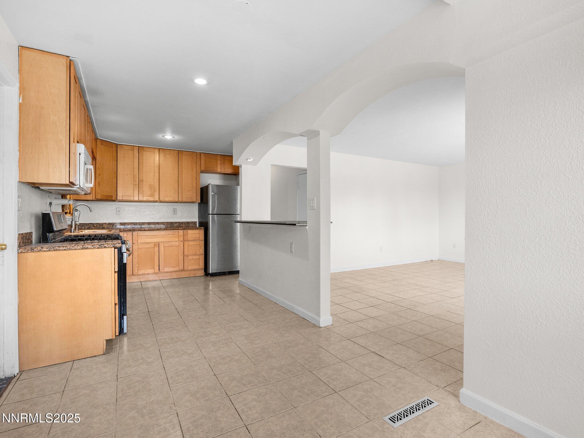 1955 Wilder Street Reno, NV 89512 - Photo 12 of 31 a kitchen with a refrigerator and a sink