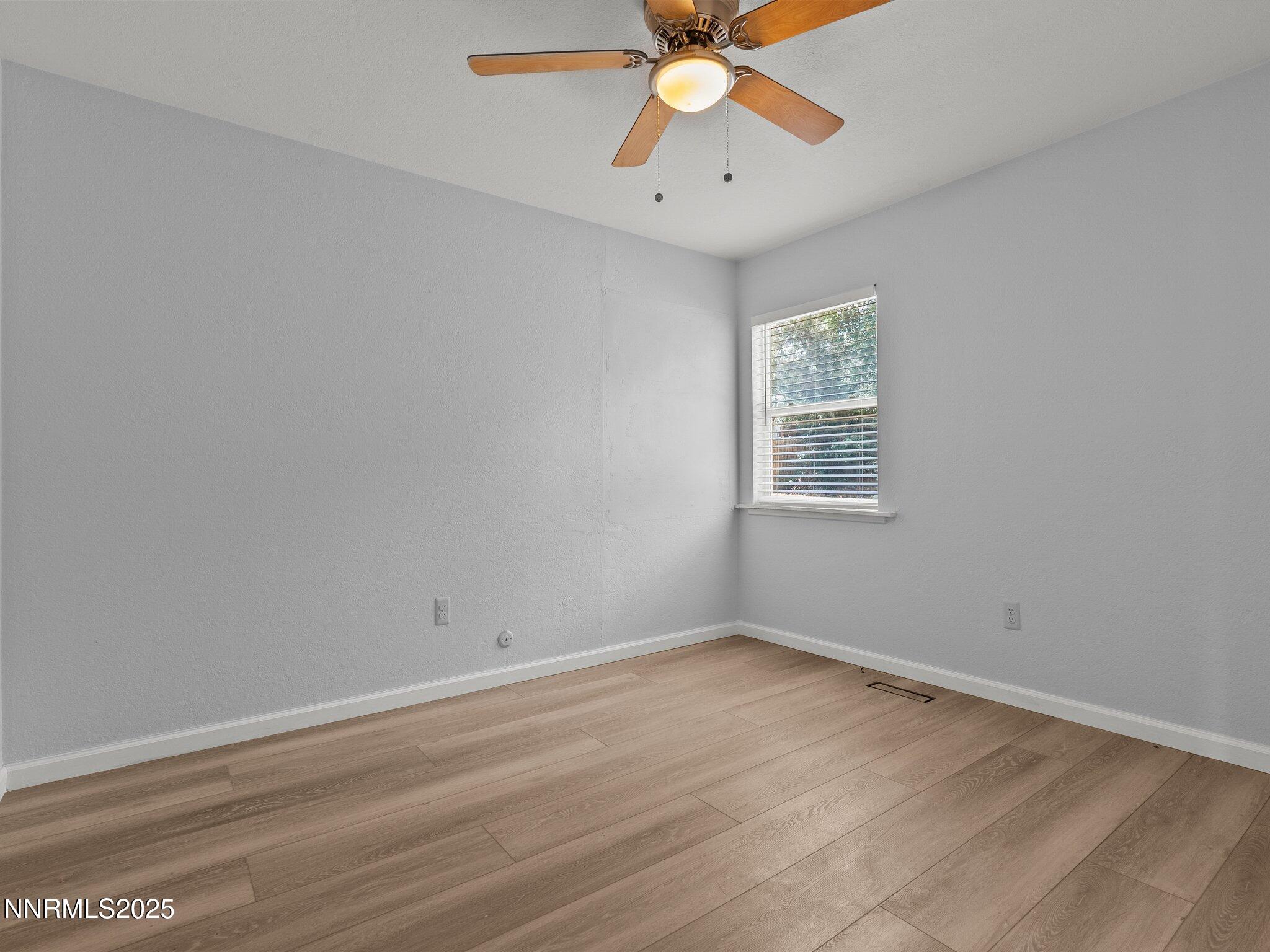 1955 Wilder Street Reno, NV 89512 - Photo 17 of 31 wooden floor in an empty room with a window