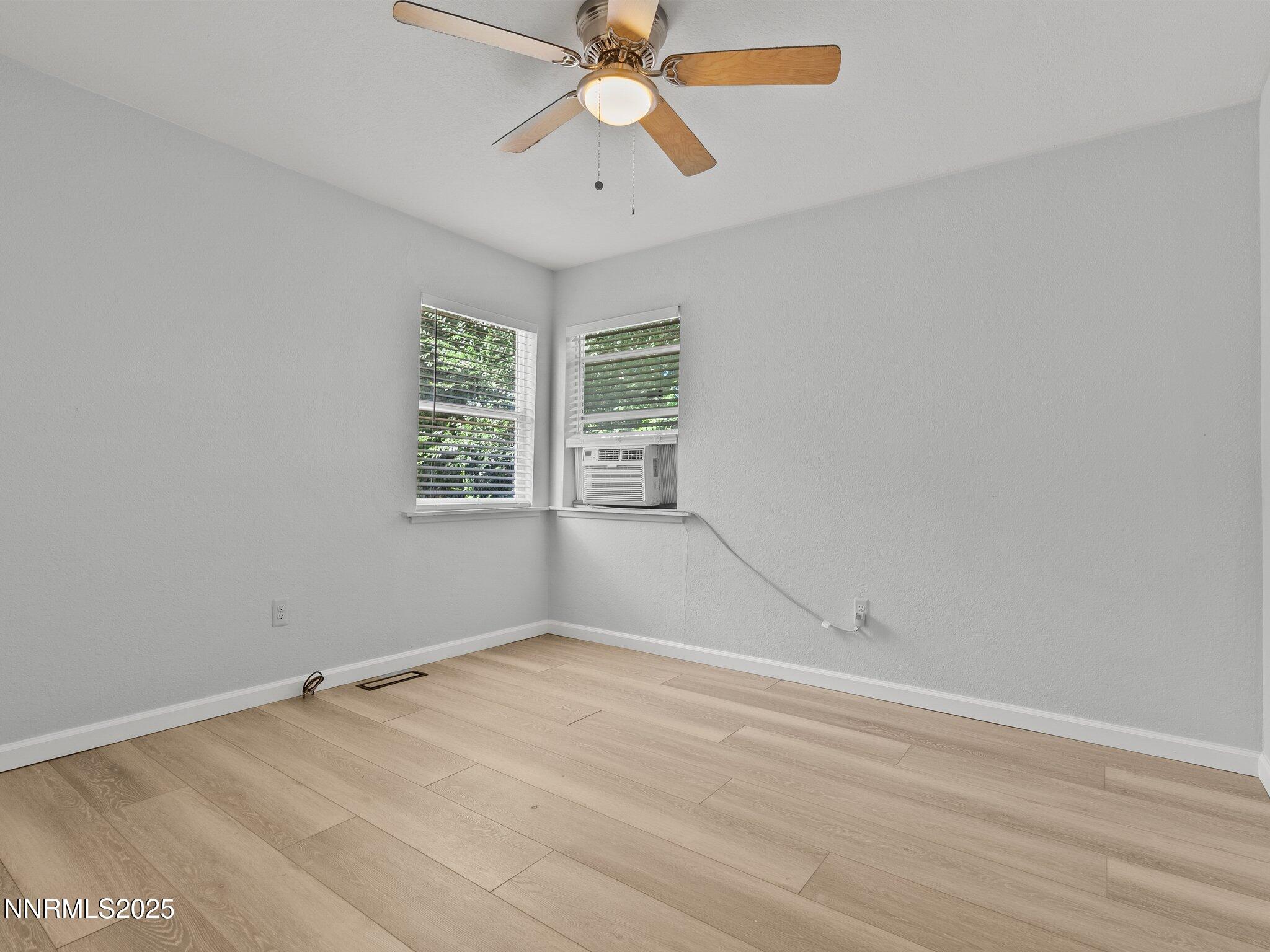 1955 Wilder Street Reno, NV 89512 - Photo 18 of 31 wooden floor in an empty room with a window