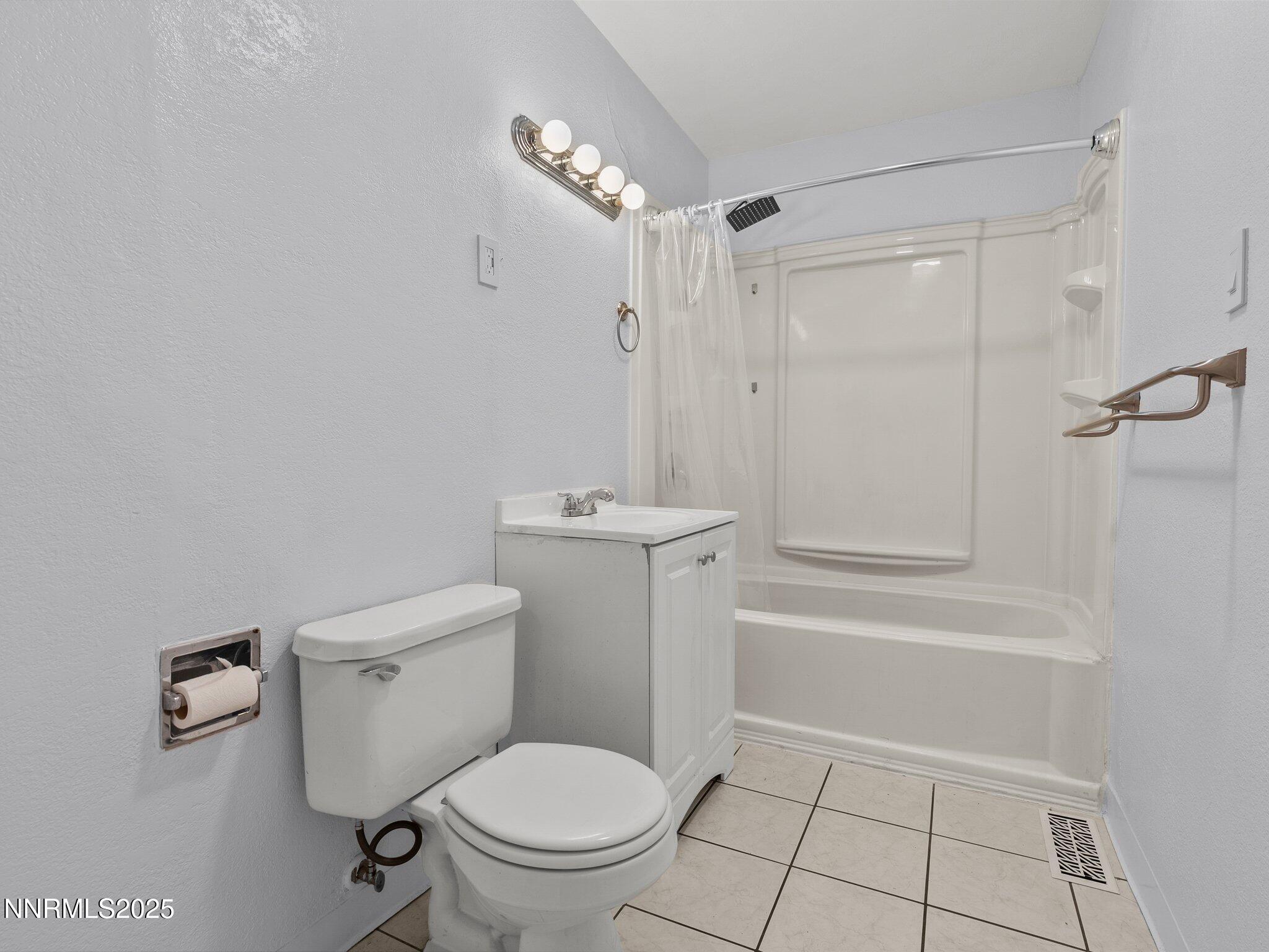 1955 Wilder Street Reno, NV 89512 - Photo 19 of 31 a bathroom with a toilet a sink and shower