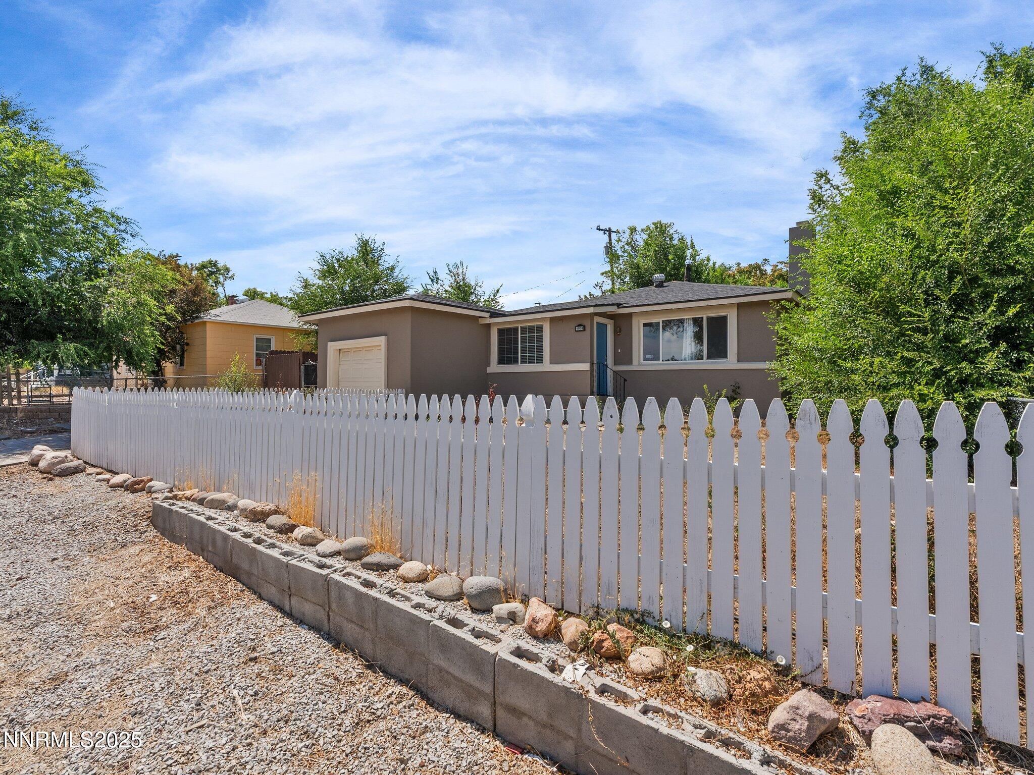 1955 Wilder Street Reno, NV 89512 - Photo 2 of 31 a view of a house with a wooden fence