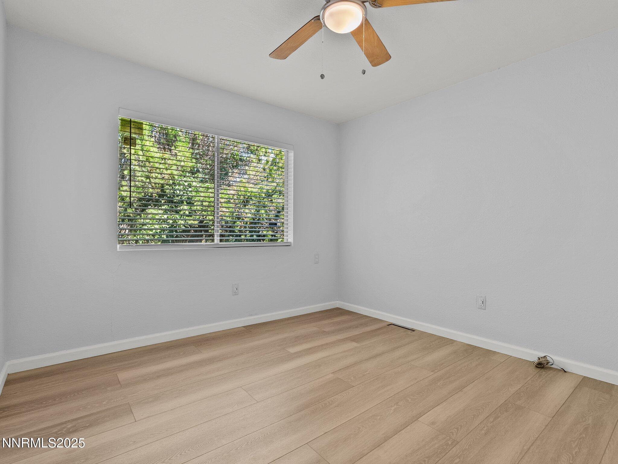 1955 Wilder Street Reno, NV 89512 - Photo 22 of 31 a view of an empty room with wooden floor and a window