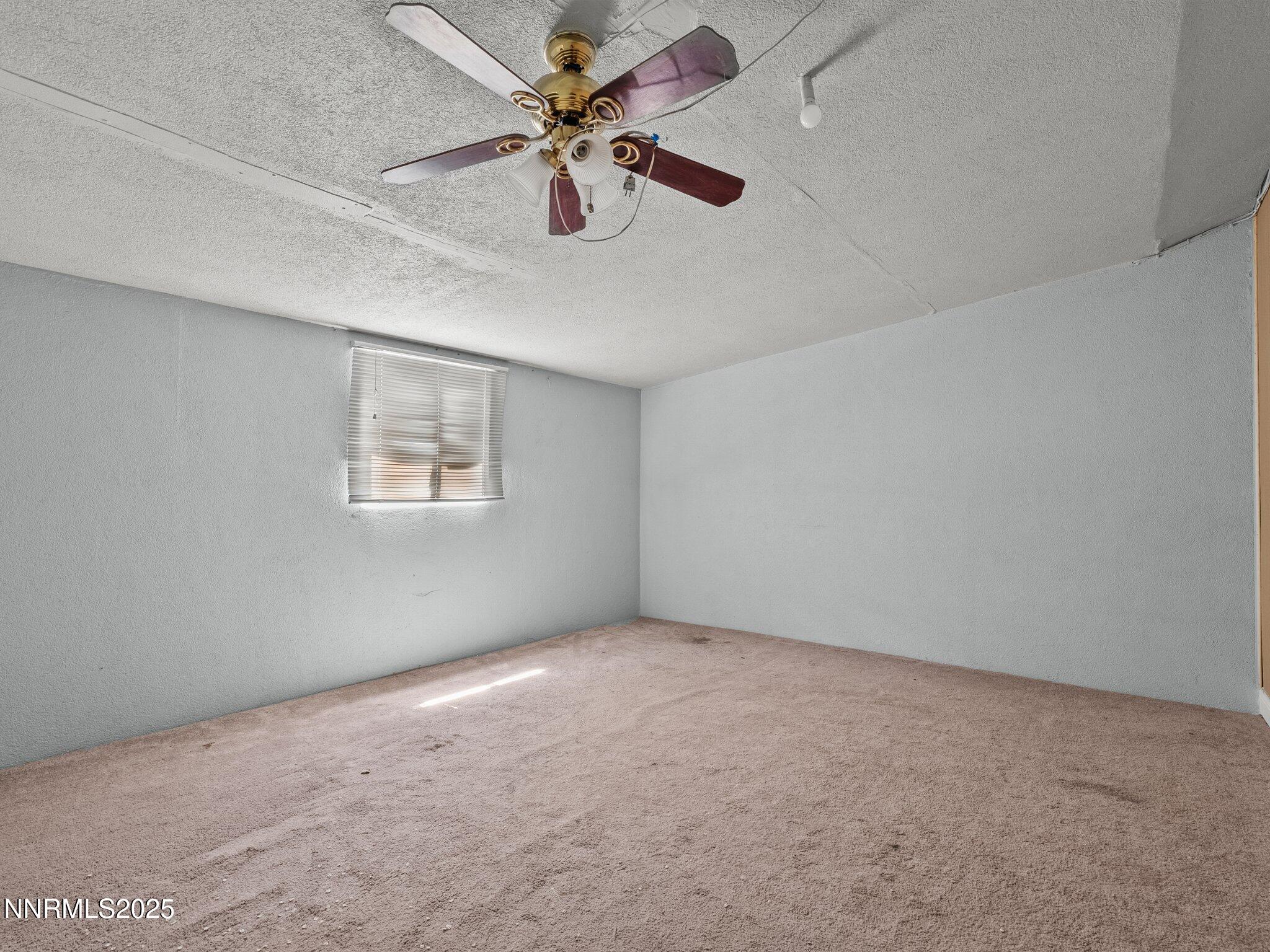 1955 Wilder Street Reno, NV 89512 - Photo 24 of 31 an empty room with a window and a fan