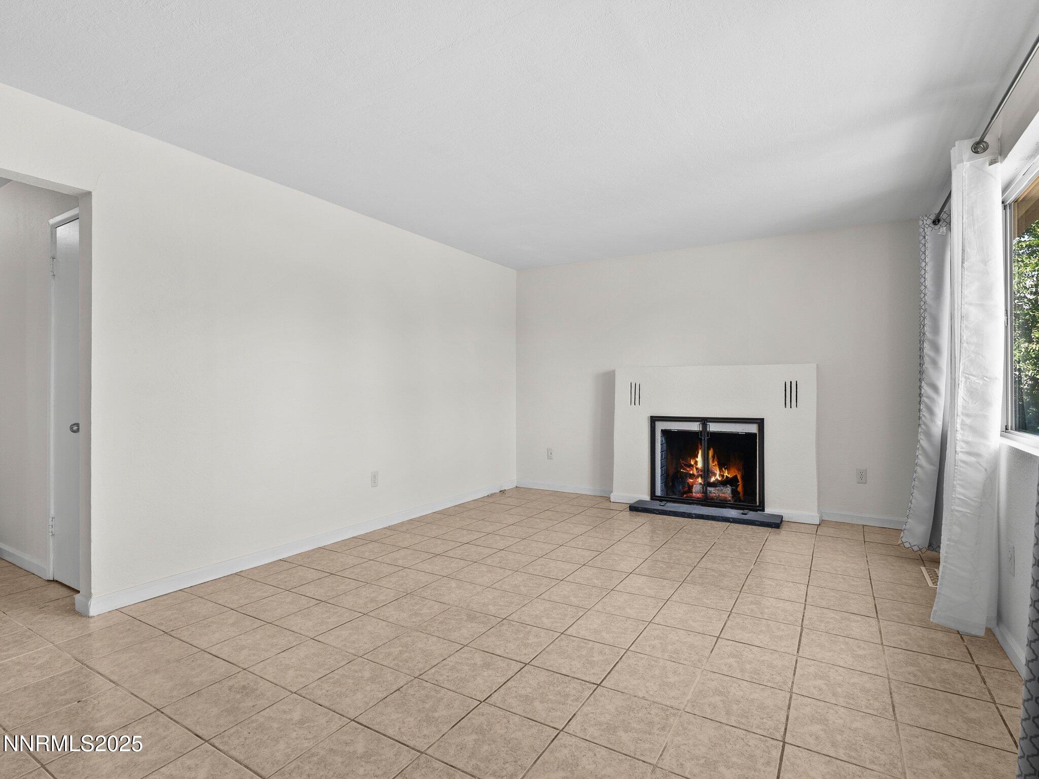 1955 Wilder Street Reno, NV 89512 - Photo 5 of 31 an empty room with a fireplace