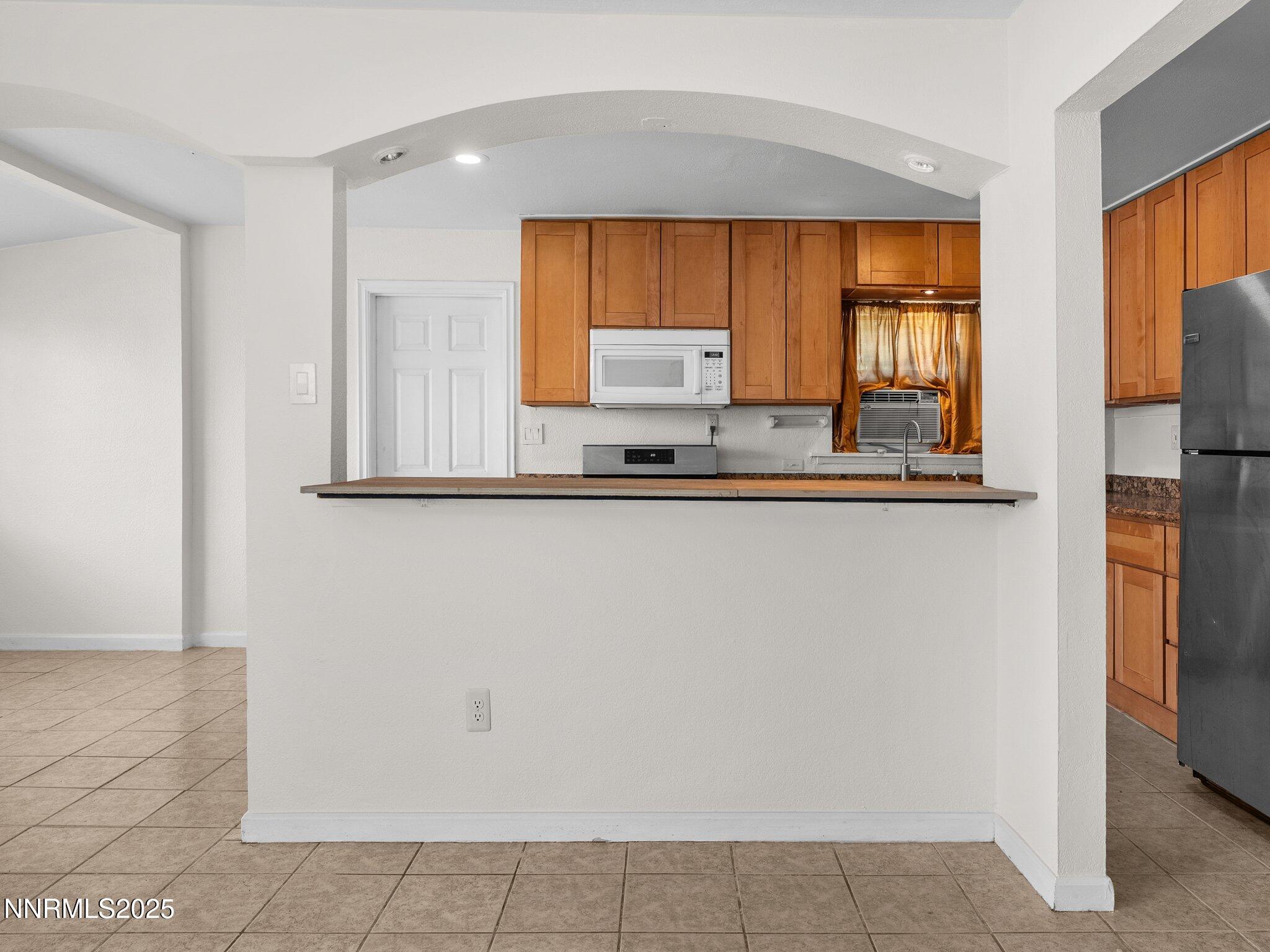 1955 Wilder Street Reno, NV 89512 - Photo 9 of 31 a kitchen with stainless steel appliances a sink and a window