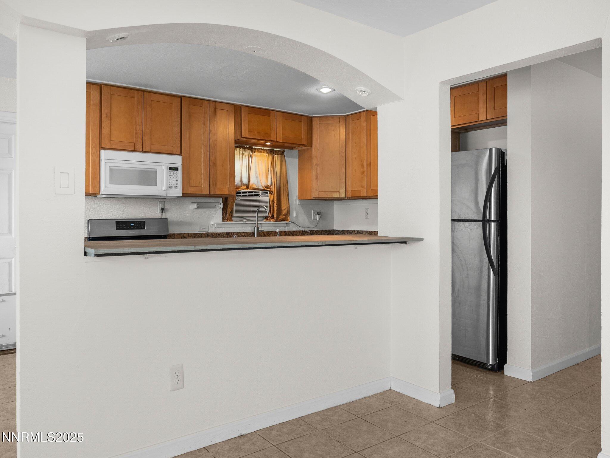 1955 Wilder Street Reno, NV 89512 - Photo 10 of 31 a kitchen with stainless steel appliances a refrigerator and a sink