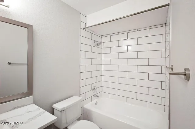 a bathroom with a bathtub and shower