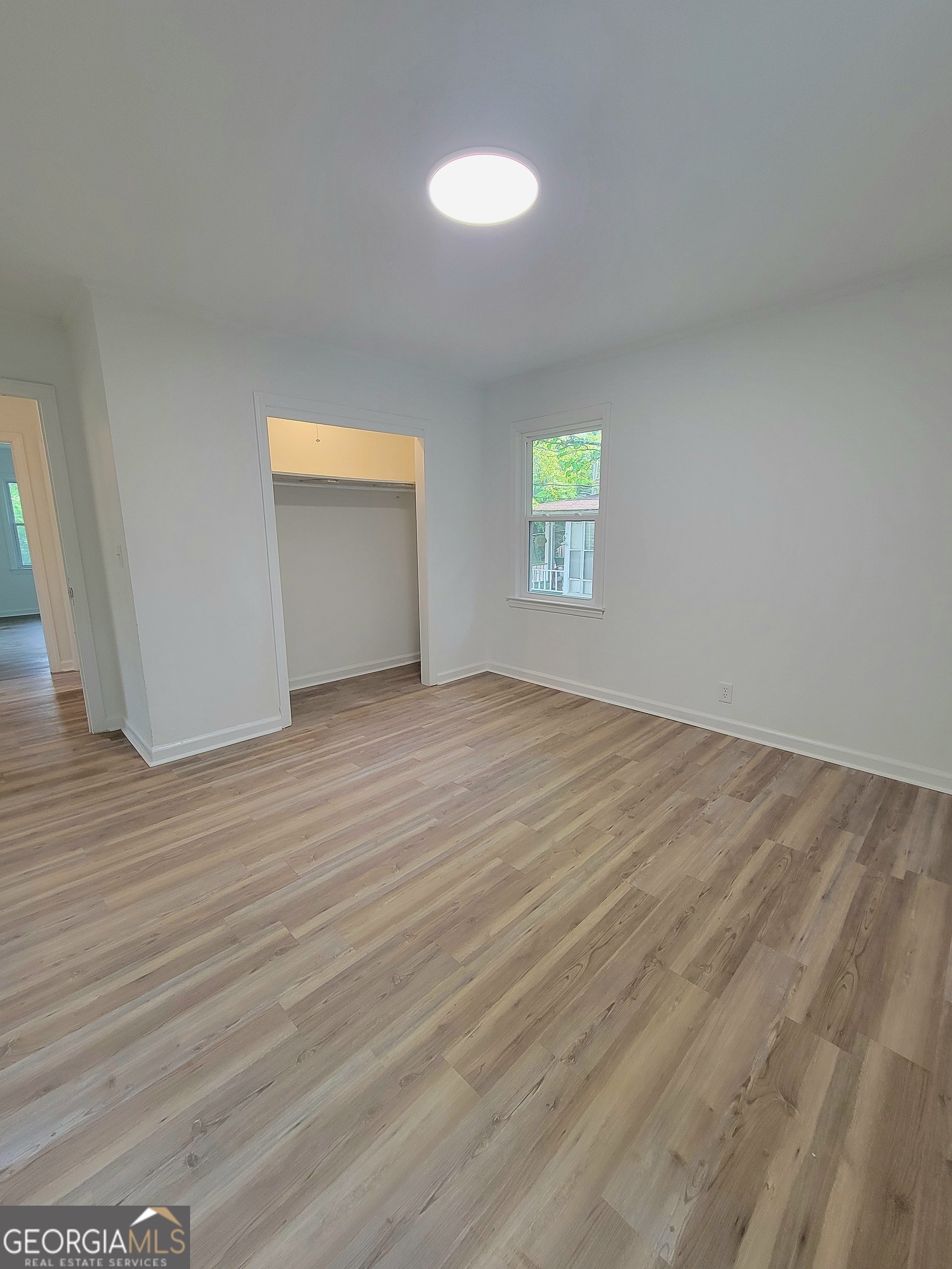 506 East 6th Street West Point, GA 31833 - Photo 13 of 15 an empty room with wooden floor and windows