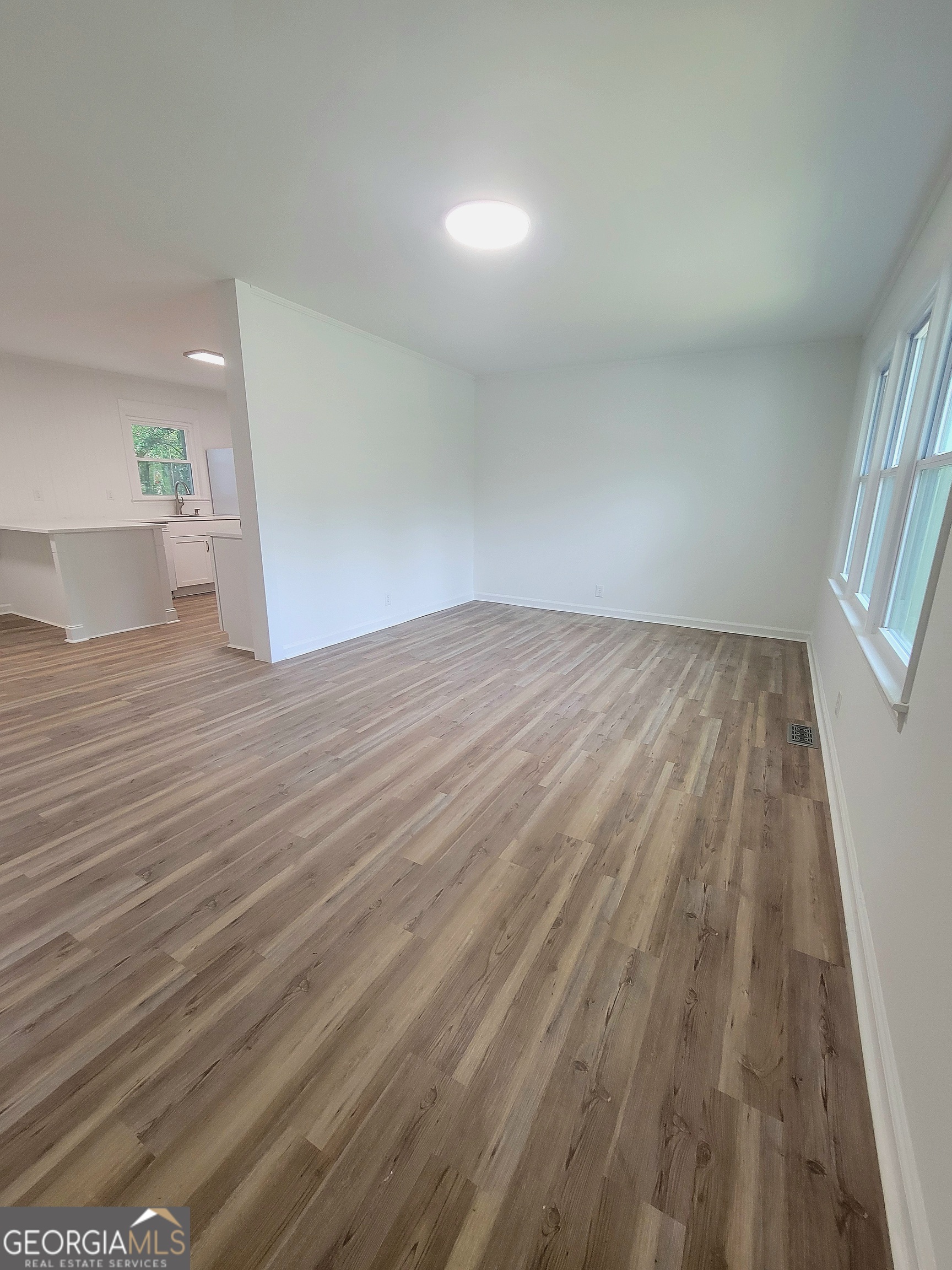 506 East 6th Street West Point, GA 31833 - Photo 5 of 15 a view of empty room with wooden floor and fan