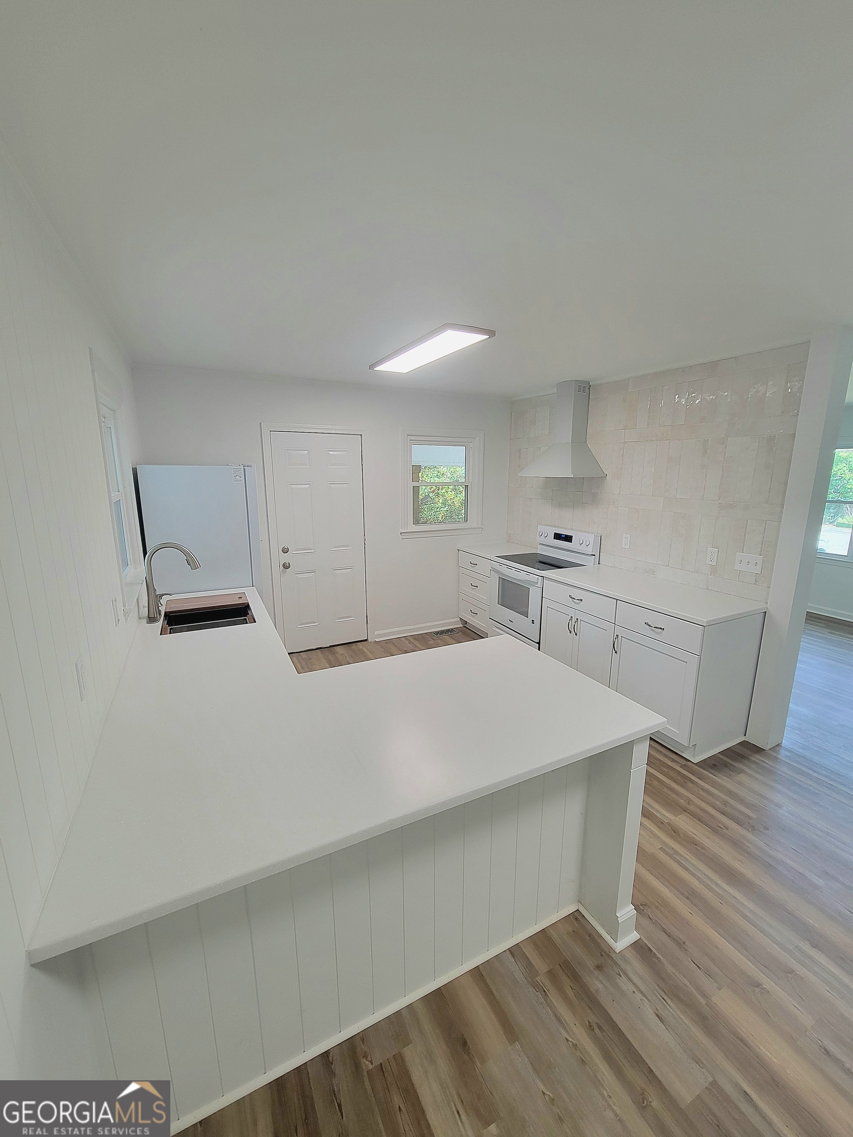 506 East 6th Street West Point, GA 31833 - Photo 6 of 15 a room with wooden floor and white walls