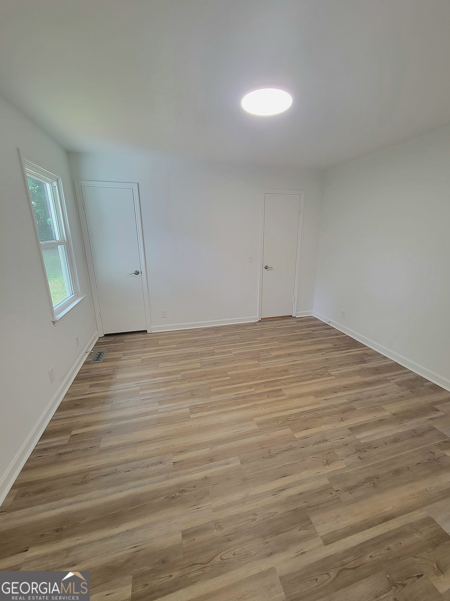 506 East 6th Street West Point, GA 31833 - Photo 8 of 15 a view of room with window and hardwood floor