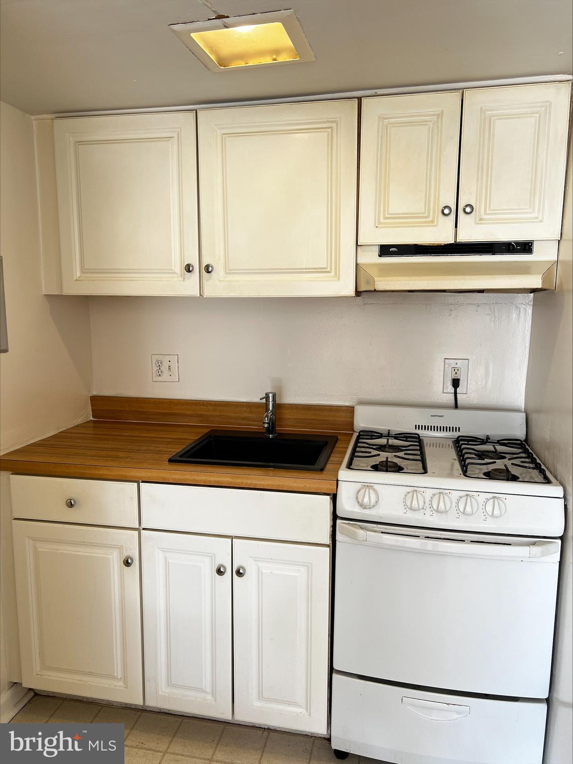 9802 Georgia Avenue, Unit 304 Silver Spring, MD 20902 - Photo 4 of 9 a utility room with dryer cabinets and a wooden floor