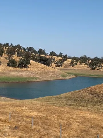 an outdoor space with swimming pool and furniture