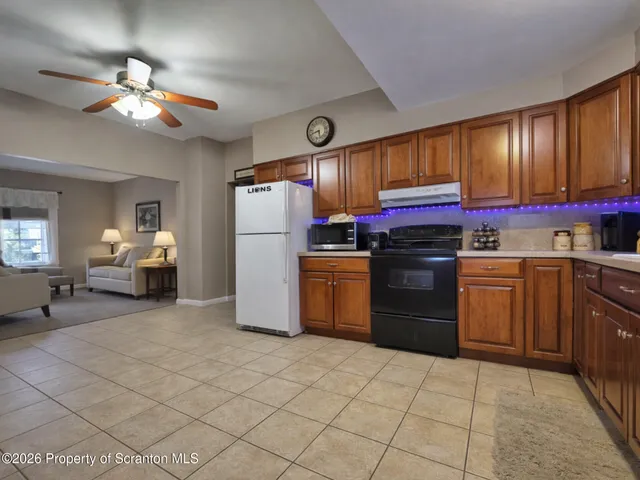 a kitchen with a refrigerator sink and cabinets