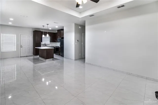 a view of a kitchen with a sink and cabinets