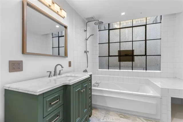 a bathroom with a toilet a sink a vanity and mirror