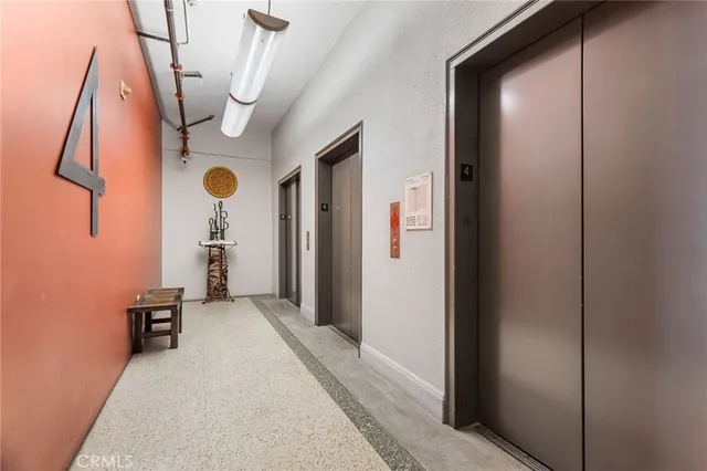 a view of a livingroom with a flesh screen tv and stairs