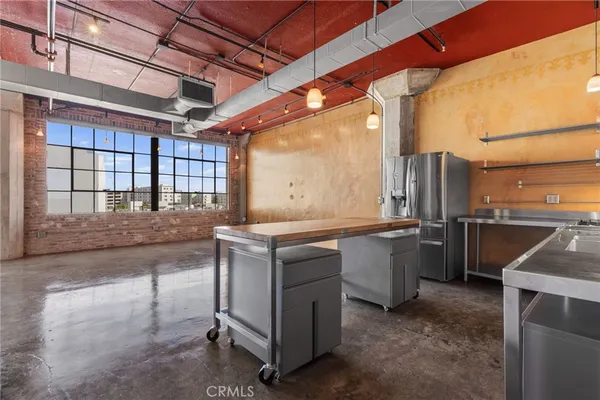 a kitchen with stainless steel appliances granite countertop a sink and cabinets