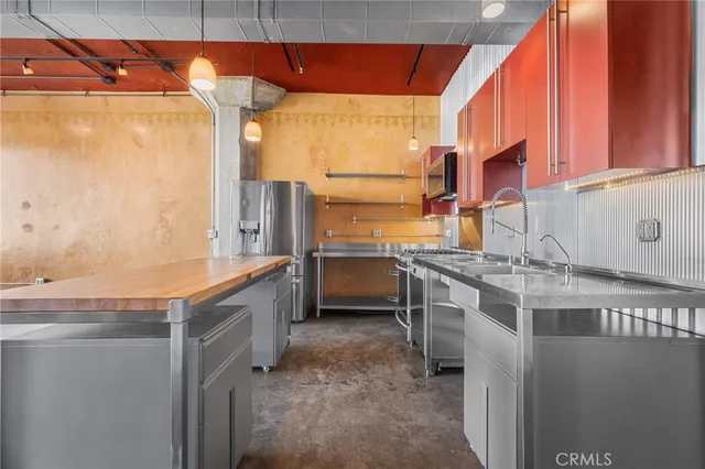 a view of a patio with a table and chairs under an umbrella