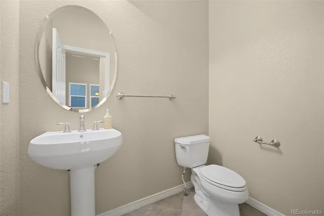 a bathroom with a sink a mirror and a toilet