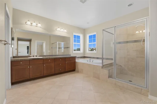 a large bathroom with a granite countertop sink mirror and a bathtub