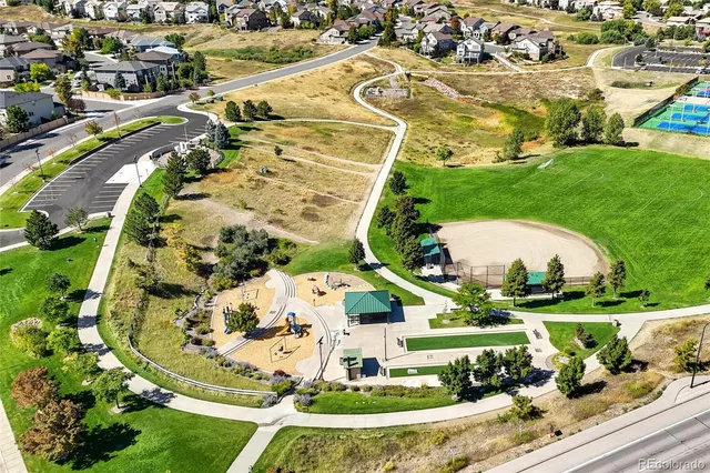 an aerial view of residential houses with outdoor space