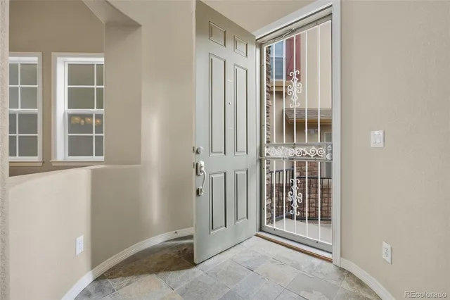 a view of a porch with wooden floor and a window