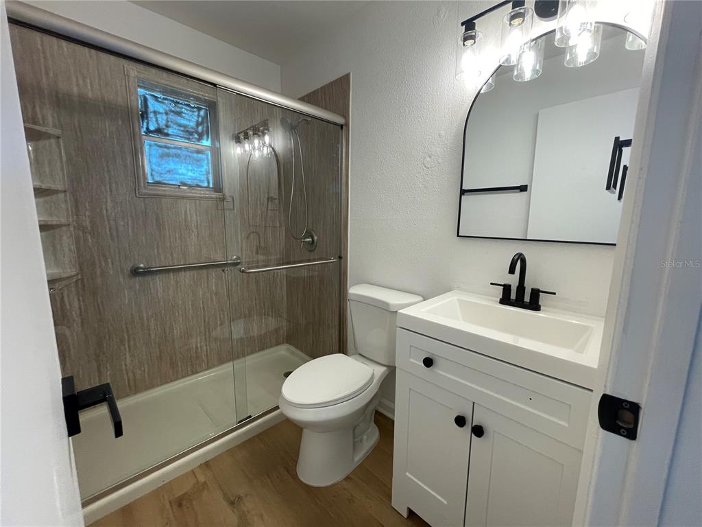 9244 Cyril Court Spring Hill, FL 34608 - Photo 20 of 30 a bathroom with a toilet sink and shower