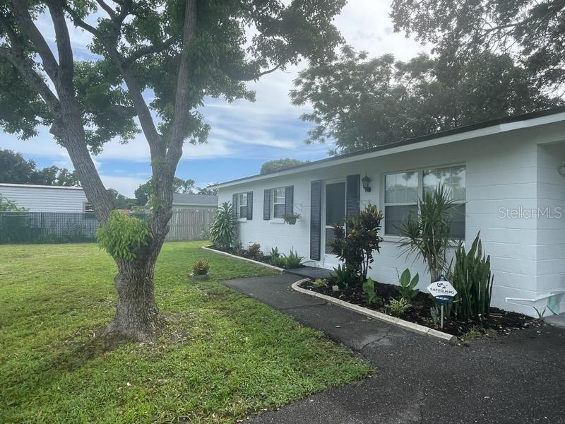 9244 Cyril Court Spring Hill, FL 34608 - Photo 2 of 30 a view of a house with backyard and garden