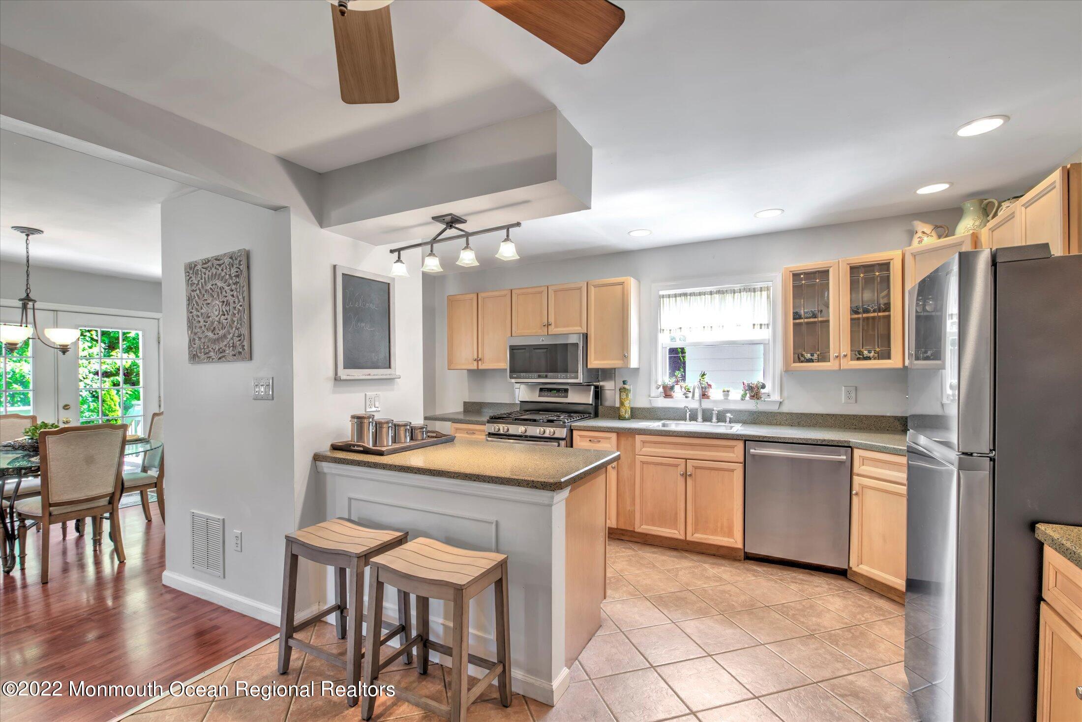 216 West Prospect Avenue Keyport, NJ 07735 - Photo 15 of 47 a kitchen with stainless steel appliances granite countertop a stove top oven a sink a dining table and chairs