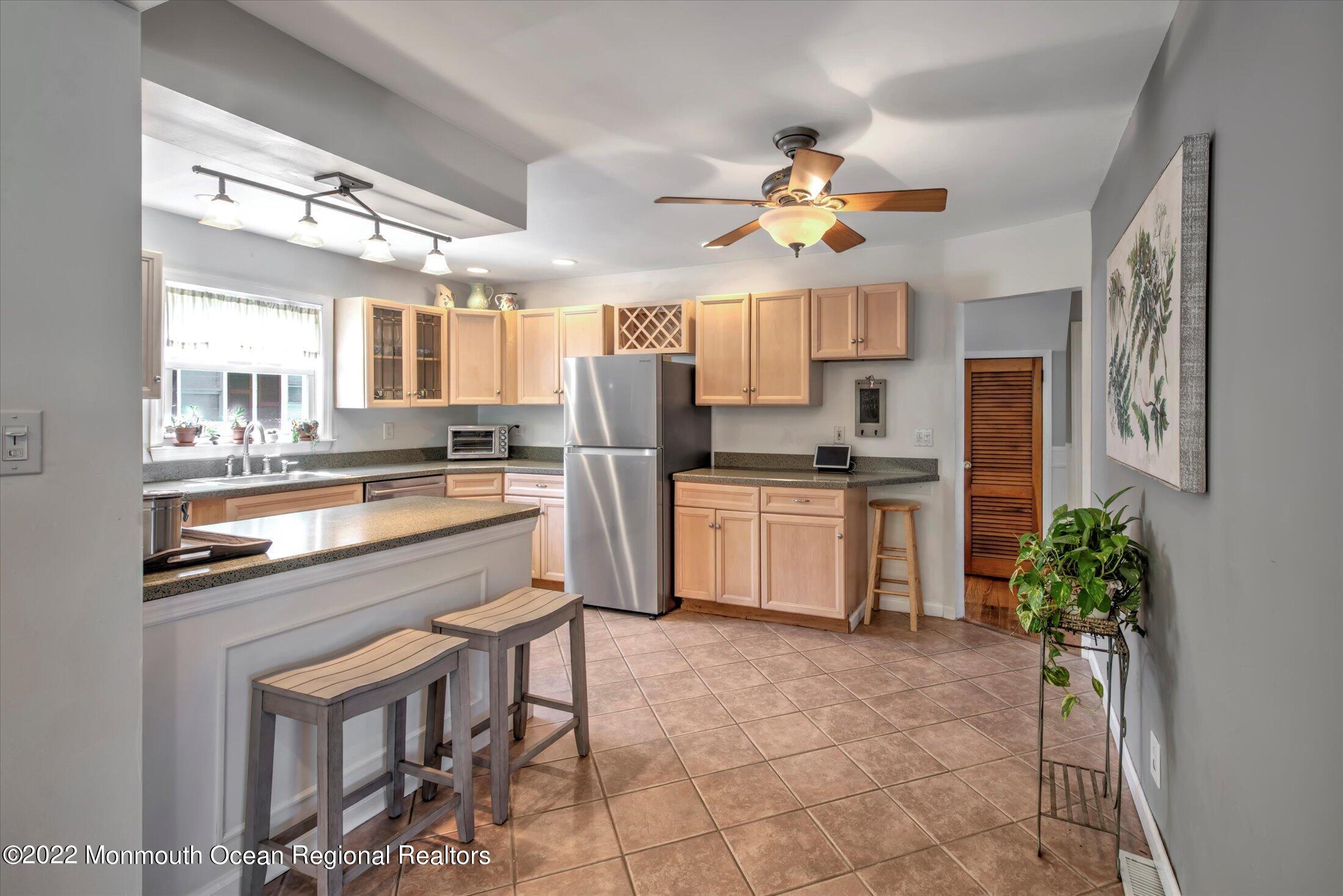 216 West Prospect Avenue Keyport, NJ 07735 - Photo 19 of 47 a kitchen with a chandelier a sink cabinets and stainless steel appliances