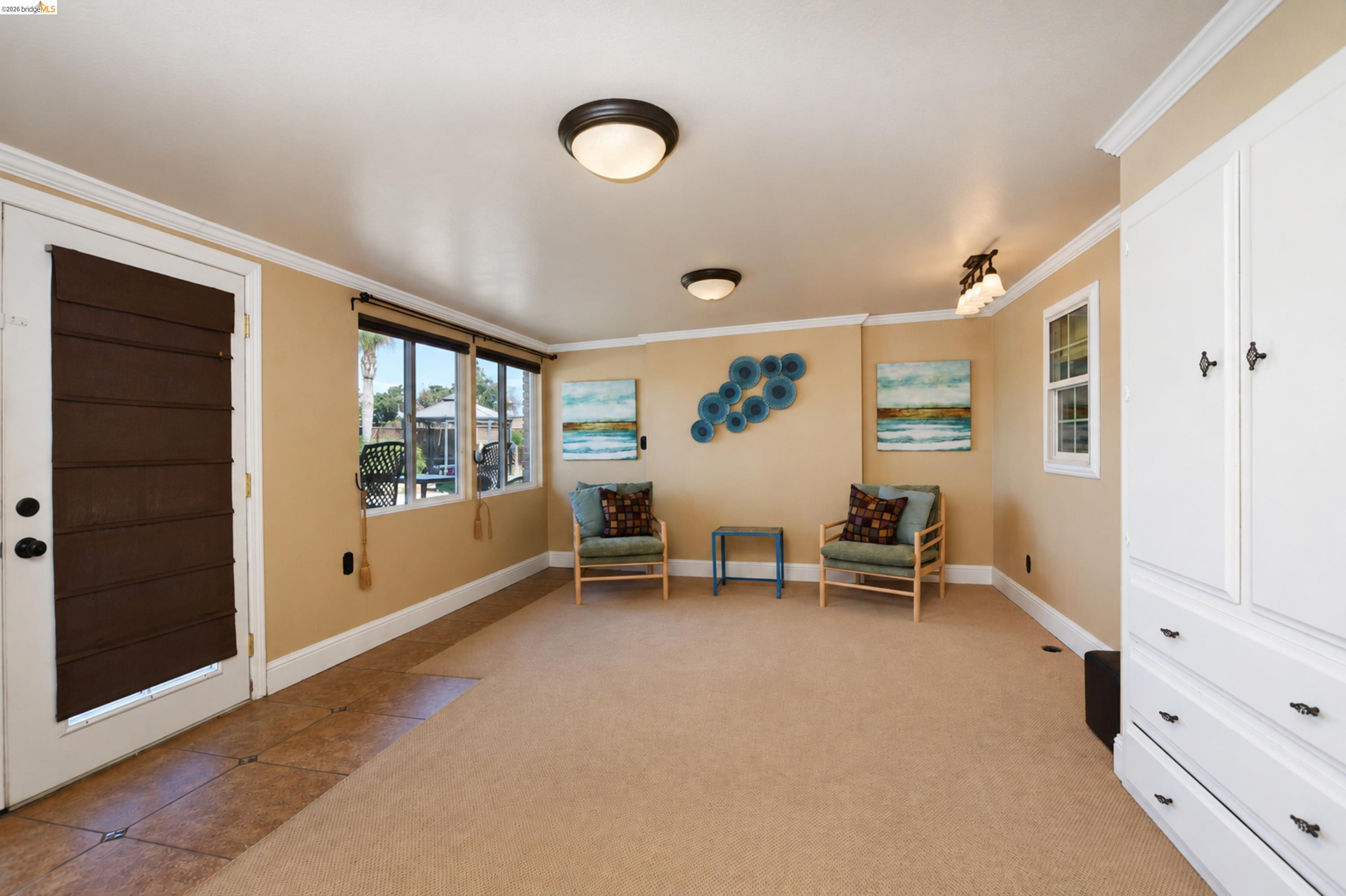 340 West Bolton Road Oakley, CA 94561 - Photo 27 of 87 Built-in white cabinetry, ceiling-mounted lighting fixtures, multiple windows with dark window treatments, and crown molding