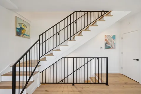 a bedroom with a bed and a potted plant