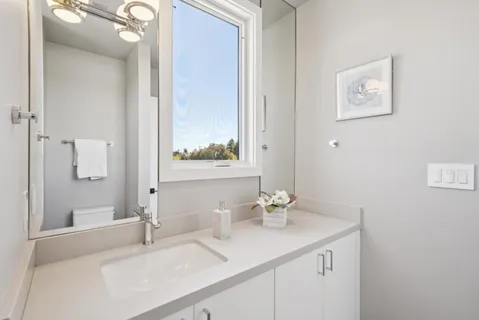 a work room with furniture a rug and a window