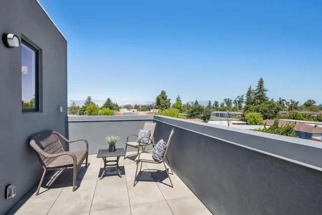 a terrace with a table and chairs