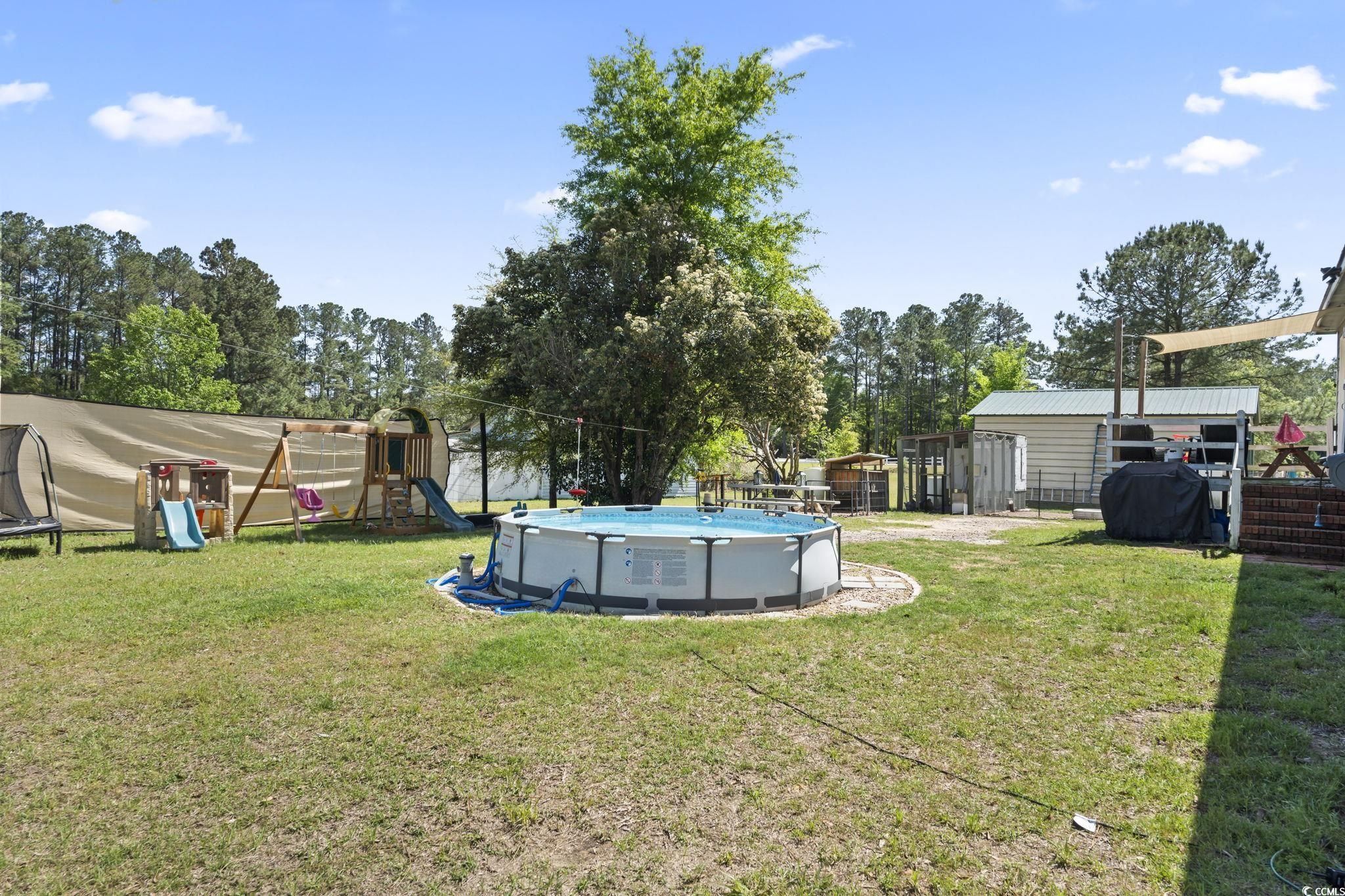 7530 Maple Swamp Road Gresham, SC 29546 - Photo 33 of 40 View of yard featuring a trampoline, an outdoor st