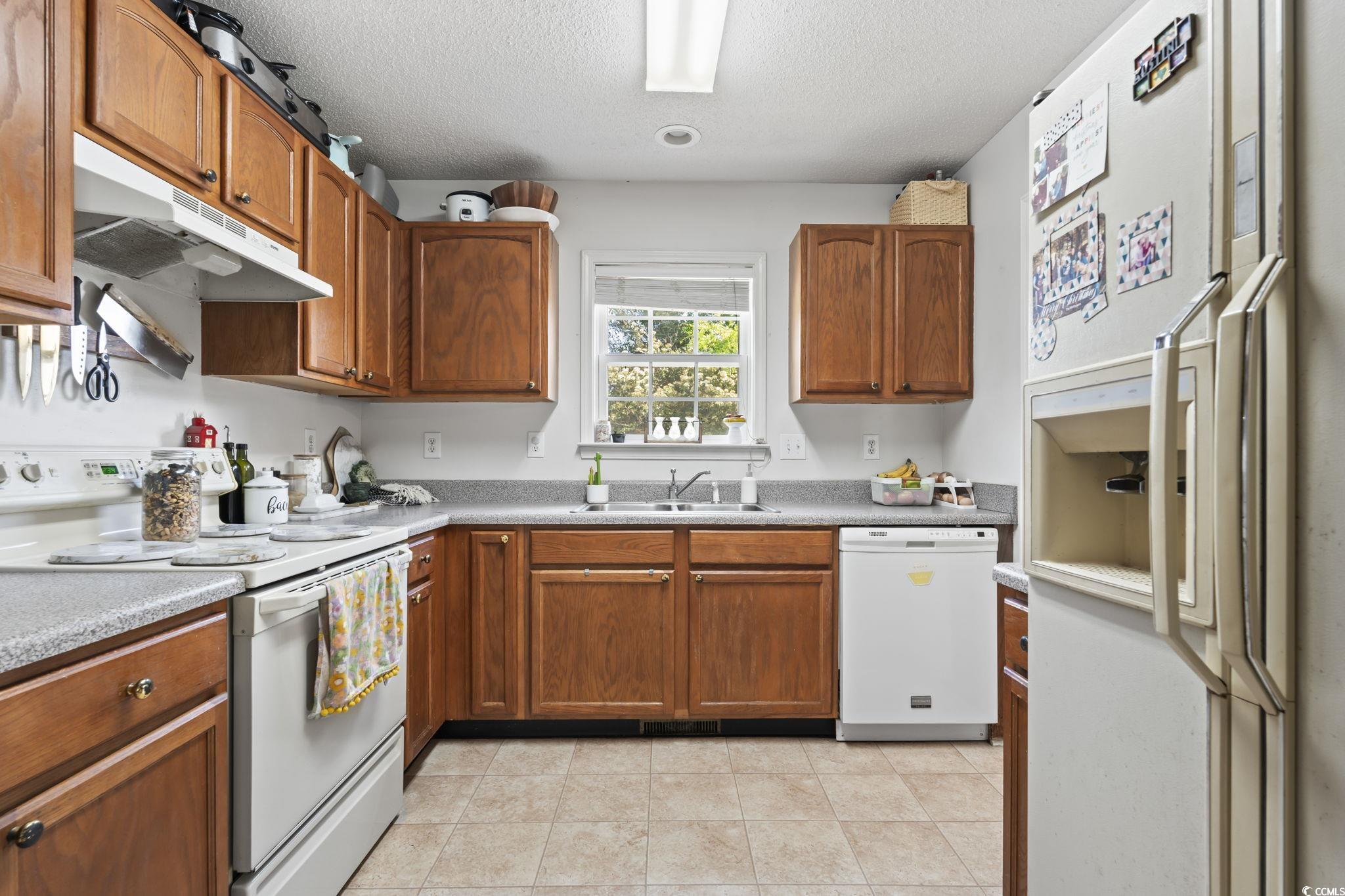 7530 Maple Swamp Road Gresham, SC 29546 - Photo 10 of 40 Kitchen with a sink, white appliances, a textured