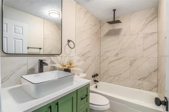 a bathroom with a sink a toilet and bathtub