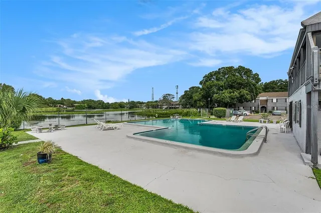 a view of a lake with a yard and potted plants